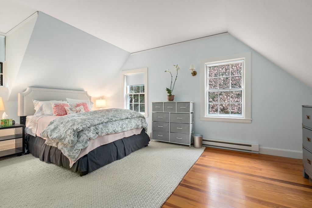 164 Forest Street, Unit 164 Sherborn, MA 01770 - Photo 24 of 32 a bedroom with a bed and a cabinets
