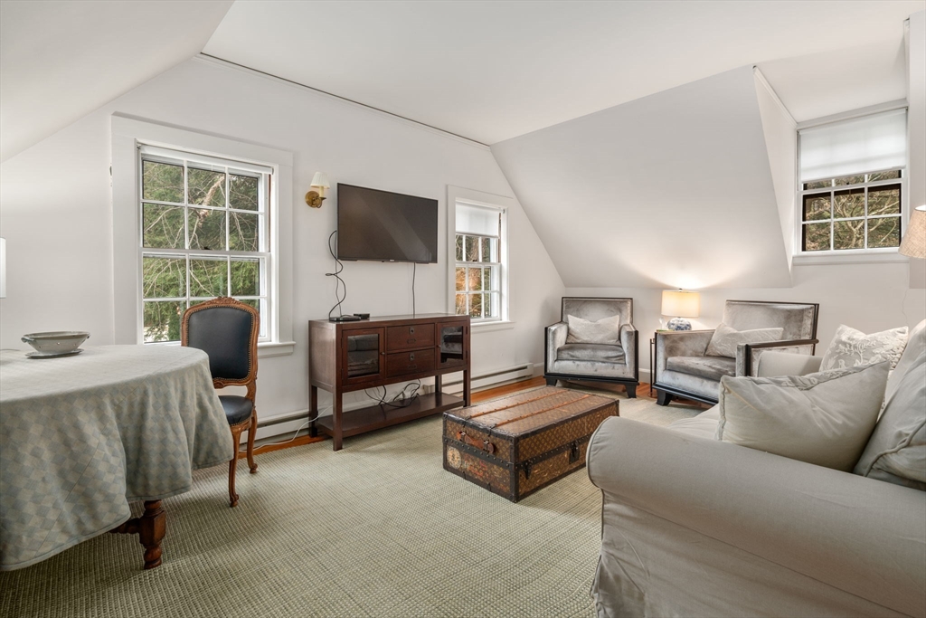 164 Forest Street, Unit 164 Sherborn, MA 01770 - Photo 25 of 32 a living room with furniture and a flat screen tv