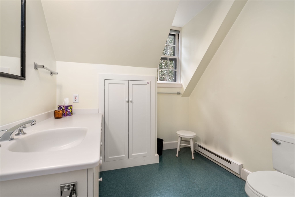 164 Forest Street, Unit 164 Sherborn, MA 01770 - Photo 26 of 32 a bathroom with a sink a toilet and tub