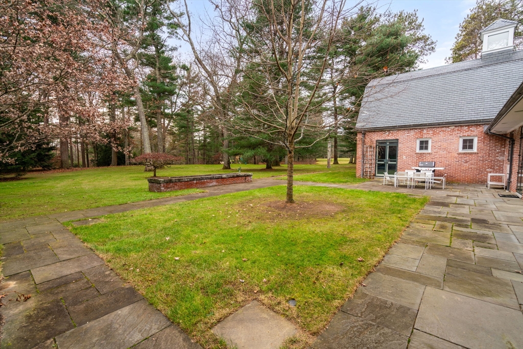 164 Forest Street, Unit 164 Sherborn, MA 01770 - Photo 27 of 32 a view of a house with a backyard