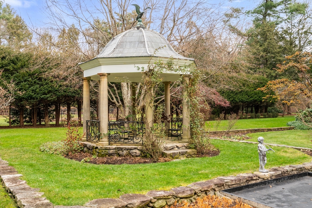 164 Forest Street, Unit 164 Sherborn, MA 01770 - Photo 31 of 32 a view of a building with a garden