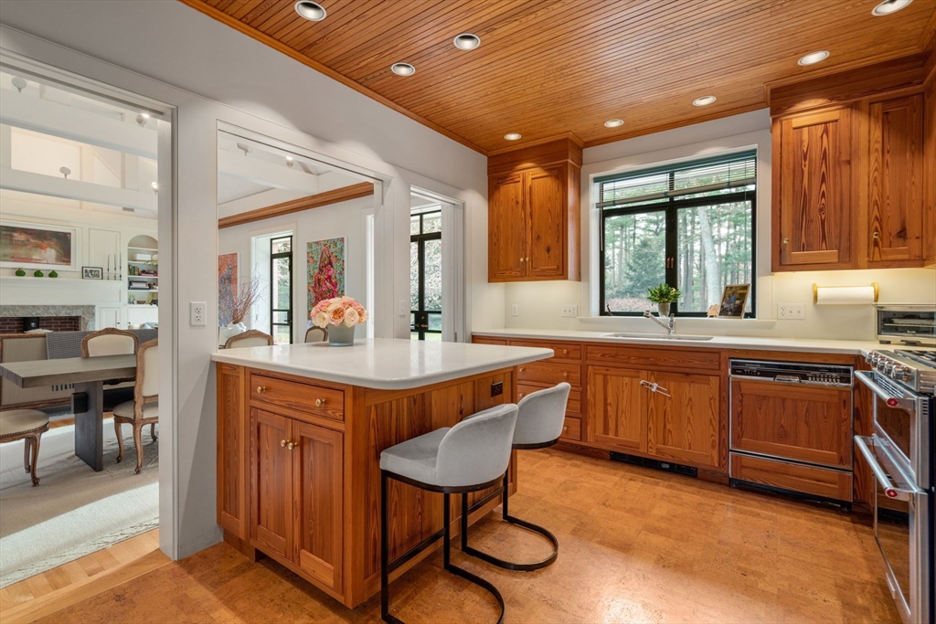 164 Forest Street, Unit 164 Sherborn, MA 01770 - Photo 9 of 32 a kitchen with stainless steel appliances granite countertop a sink a stove and a refrigerator