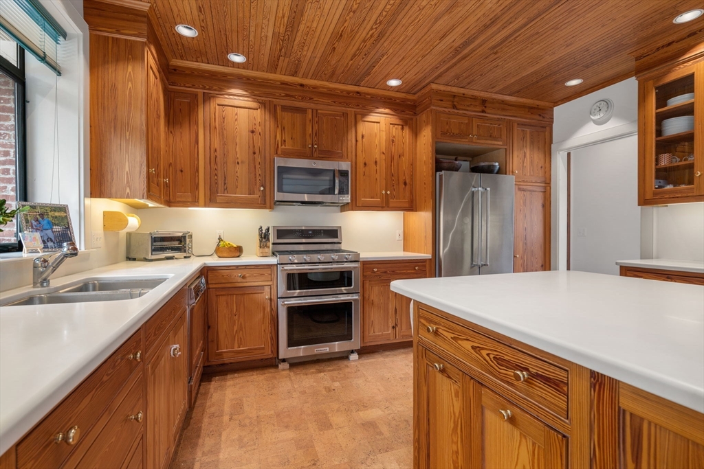 164 Forest Street, Unit 164 Sherborn, MA 01770 - Photo 10 of 32 a kitchen that has a sink and stainless steel appliances