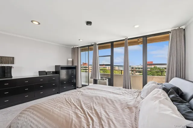 a bed room with a bed and a large window