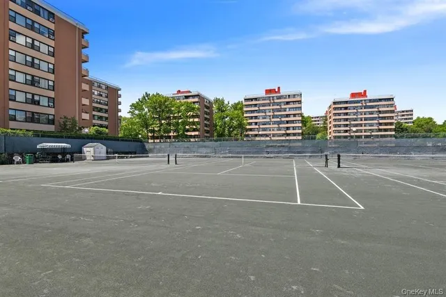 a tennis court with view of tall buildings