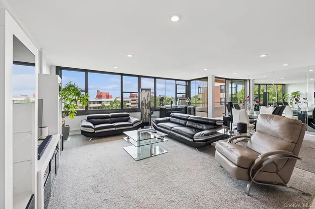 a living room with furniture a rug and a large window