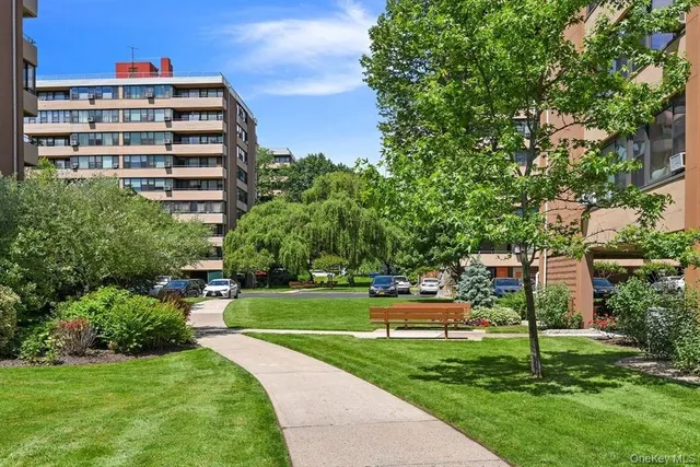 a view of a big yard and a building in the background
