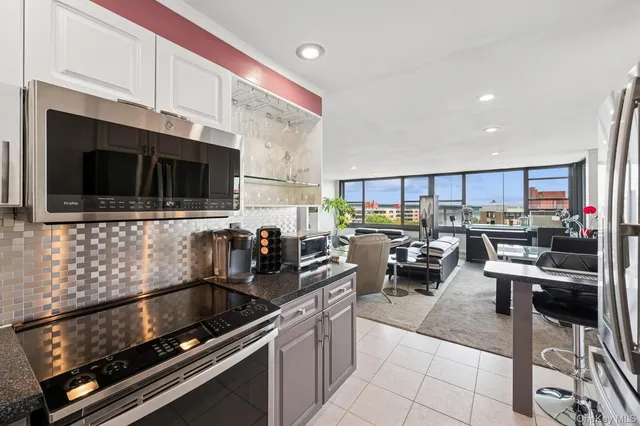 a kitchen with lots of counter top space a stove and cabinets