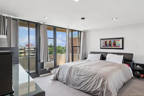 a bedroom with a large bed and a large window
