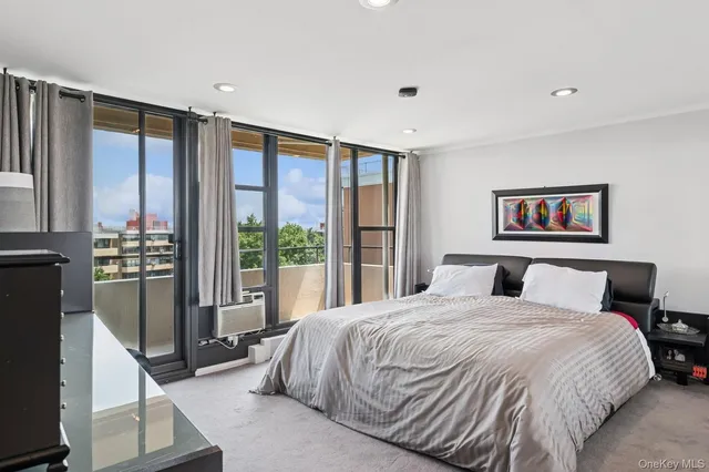 a bedroom with a large bed and a large window