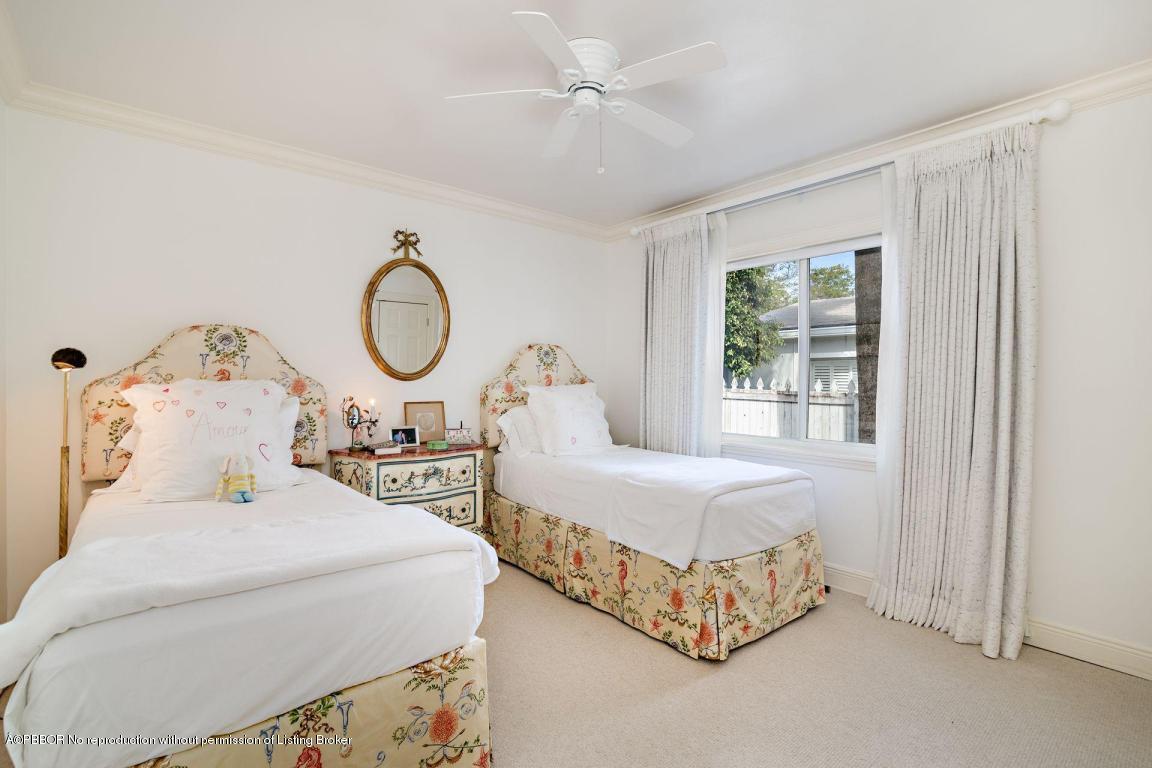 256 Alpine Road West Palm Beach, FL 33405 - Photo 11 of 26 a bedroom with bed and a chandelier
