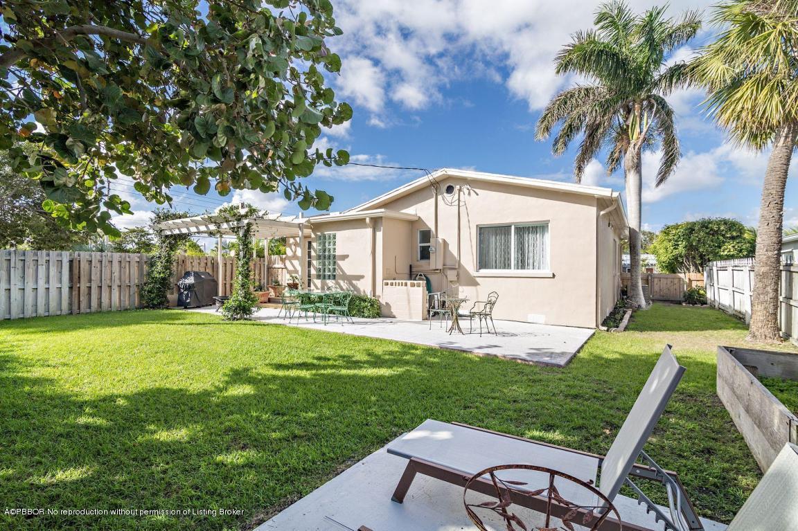 256 Alpine Road West Palm Beach, FL 33405 - Photo 16 of 26 a view of a house with a yard and sitting area