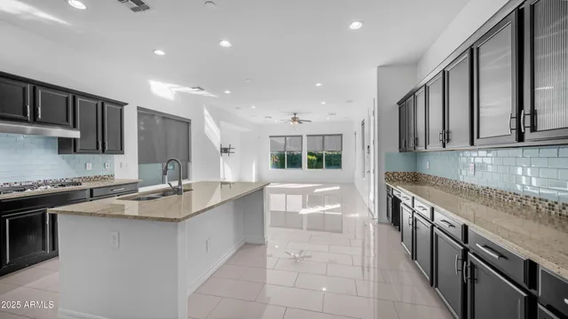 a kitchen with stainless steel appliances granite countertop a sink stove and cabinets