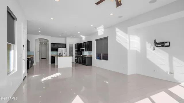 a view of a kitchen with refrigerator and windows