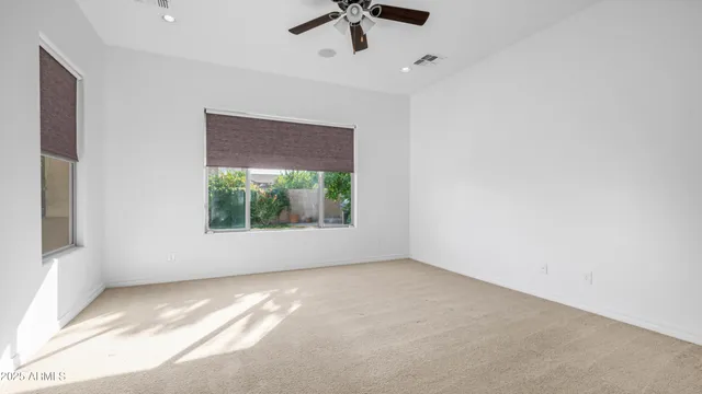 a view of room with window and ceiling fan