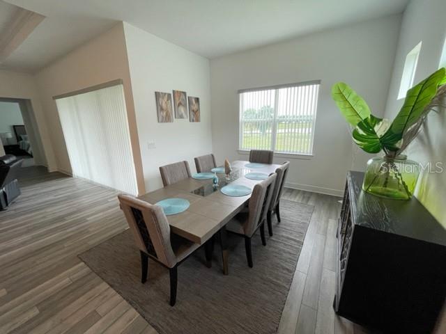 5936 Southwest 90th Court Road Ocala, FL 34481 - Photo 11 of 28 a view of a dining room with furniture window and wooden floor