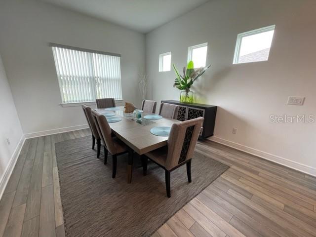 5936 Southwest 90th Court Road Ocala, FL 34481 - Photo 12 of 28 a view of a dining room with furniture and wooden floor