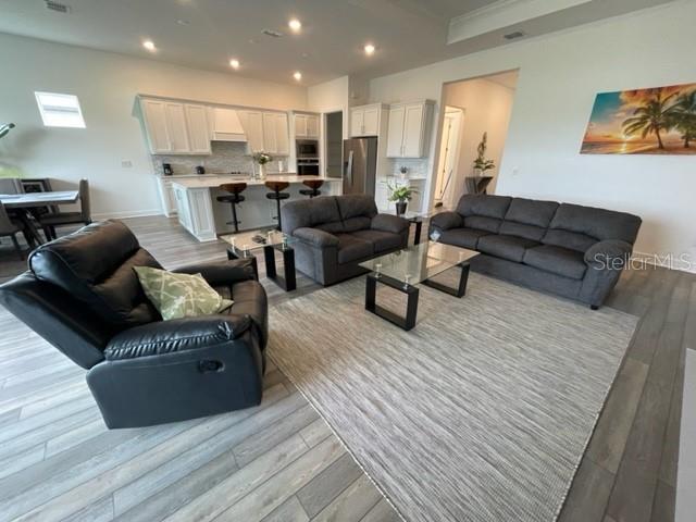 5936 Southwest 90th Court Road Ocala, FL 34481 - Photo 14 of 28 a living room with furniture and a wooden floor