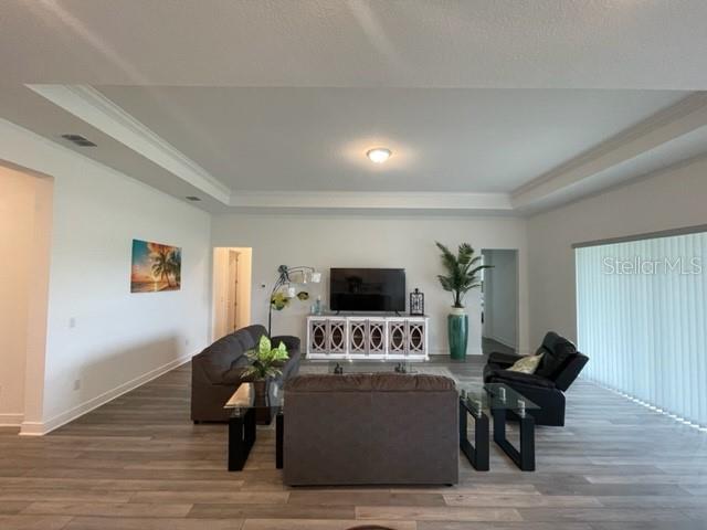 5936 Southwest 90th Court Road Ocala, FL 34481 - Photo 15 of 28 a living room with furniture and a flat screen tv