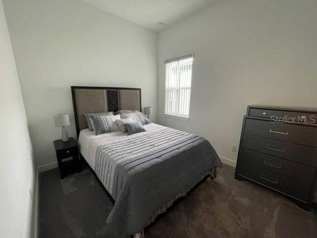 5936 Southwest 90th Court Road Ocala, FL 34481 - Photo 21 of 28 a bedroom with a bed and a window