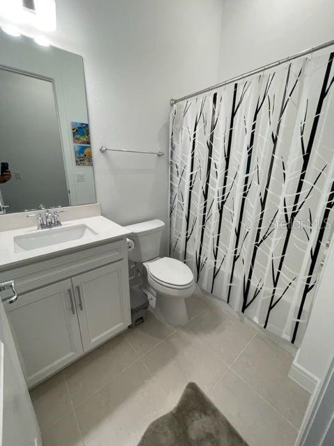 5936 Southwest 90th Court Road Ocala, FL 34481 - Photo 22 of 28 a spacious bathroom with a toilet a sink and a mirror