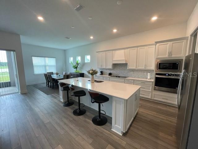 5936 Southwest 90th Court Road Ocala, FL 34481 - Photo 7 of 28 a kitchen with a sink a microwave and cabinets