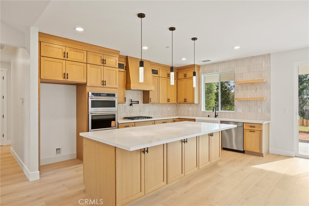 6006 Kibler Road Paradise, CA 95969 - Photo 12 of 43 a kitchen with stainless steel appliances granite countertop a stove a sink a refrigerator and a oven