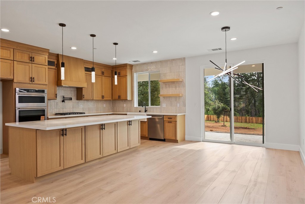 6006 Kibler Road Paradise, CA 95969 - Photo 20 of 43 a large kitchen with kitchen island a large counter top a sink stainless steel appliances and cabinets
