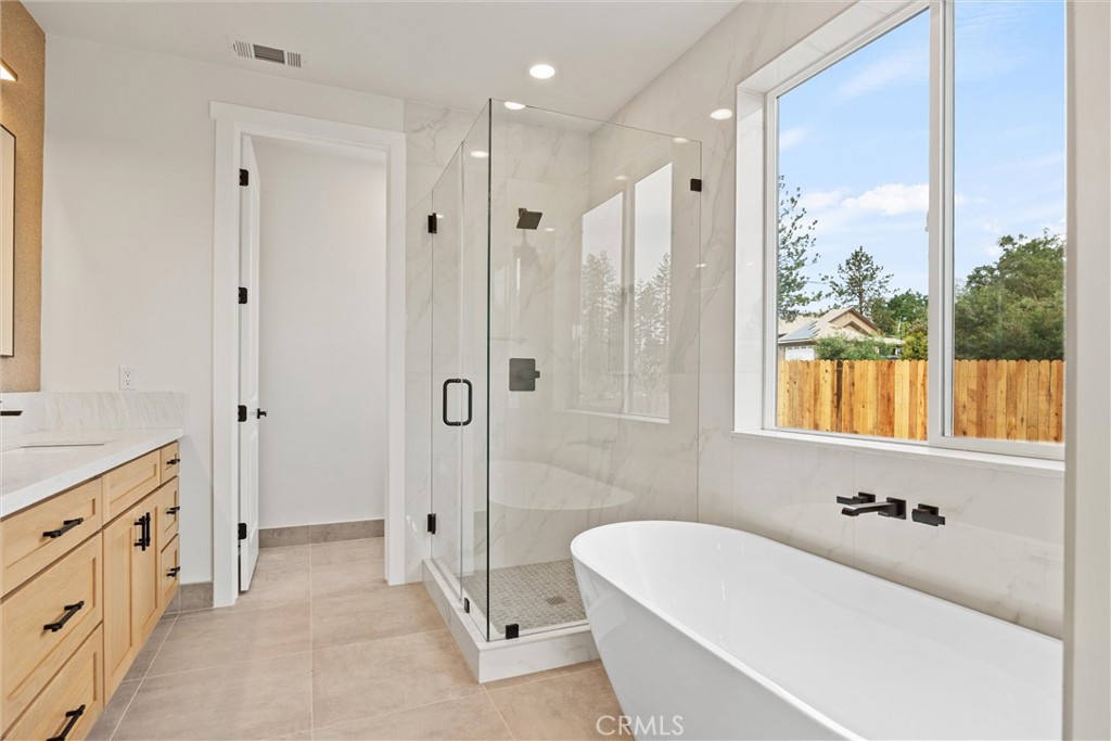 6006 Kibler Road Paradise, CA 95969 - Photo 25 of 43 a bathroom with a tub a sink a window and a shower