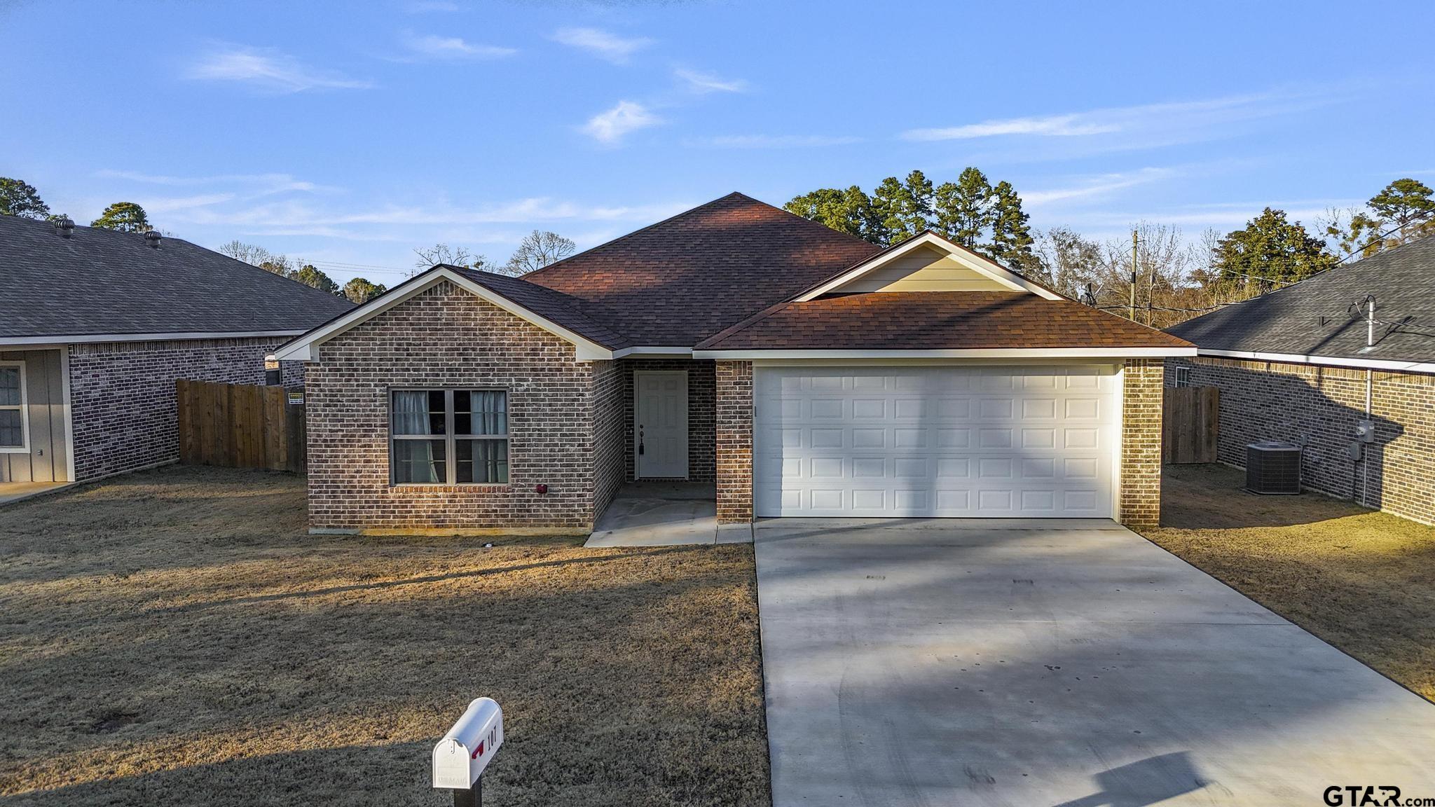 107 Short Street Gilmer, TX 75645 - Photo 1 of 26 front view of a house with a garage