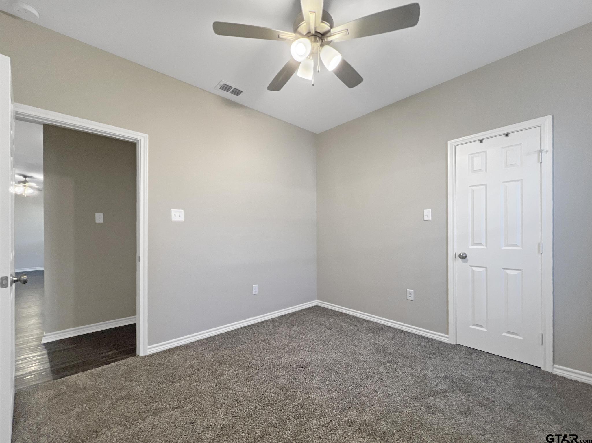 107 Short Street Gilmer, TX 75645 - Photo 12 of 26 an empty room with closet and a chandelier fan