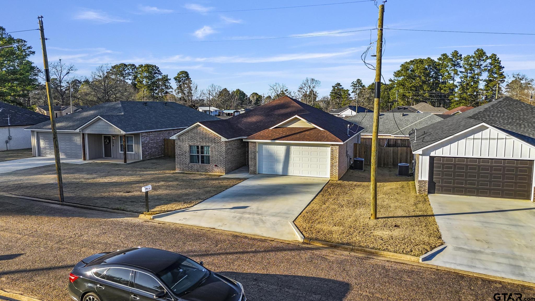 107 Short Street Gilmer, TX 75645 - Photo 21 of 26 a front view of a house with a yard