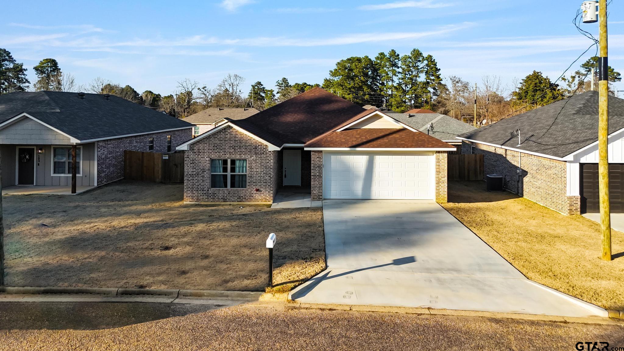 107 Short Street Gilmer, TX 75645 - Photo 24 of 26 a front view of a house with a yard