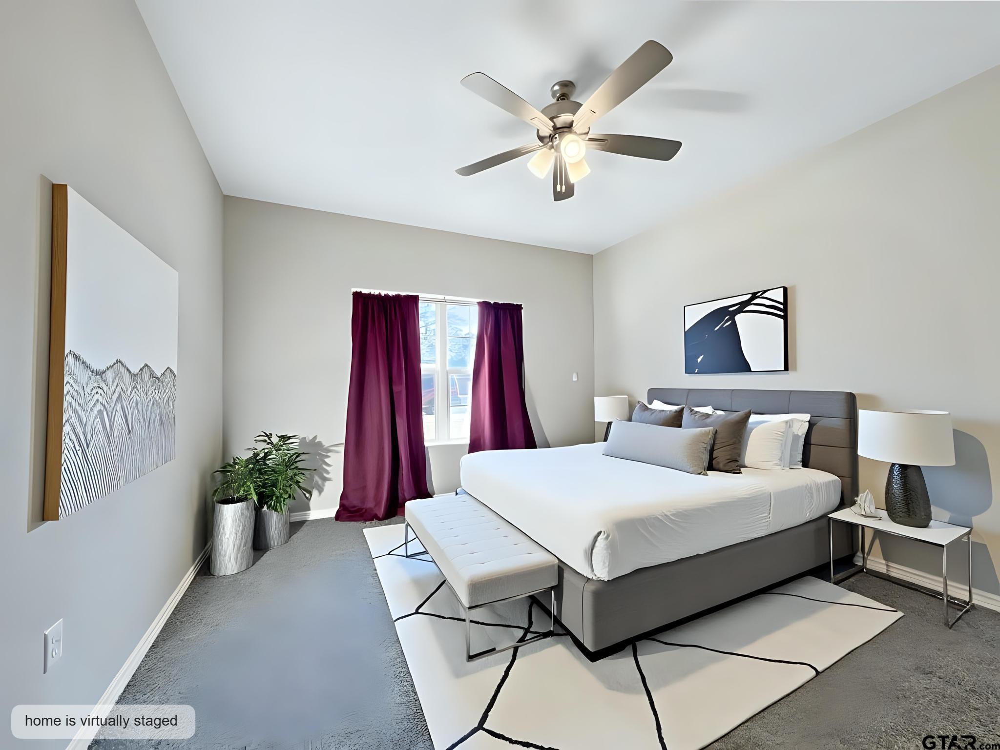 107 Short Street Gilmer, TX 75645 - Photo 8 of 26 a bedroom with a large bed and a chandelier