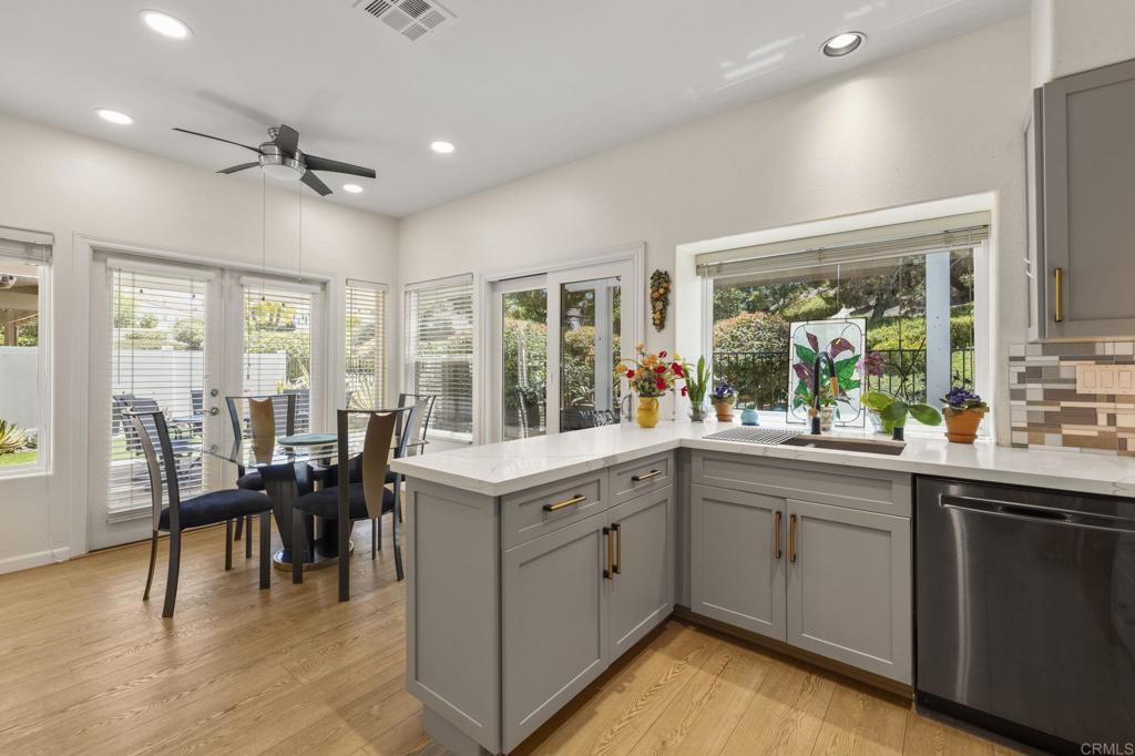 4939 Tilos Way Oceanside, CA 92056 - Photo 17 of 49 a kitchen with sink cabinets and dining table