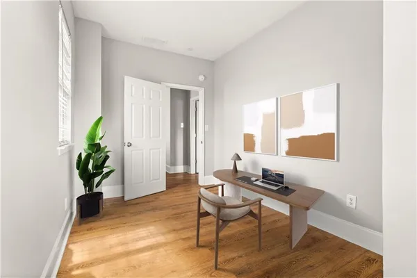 a living room with furniture and a potted plant
