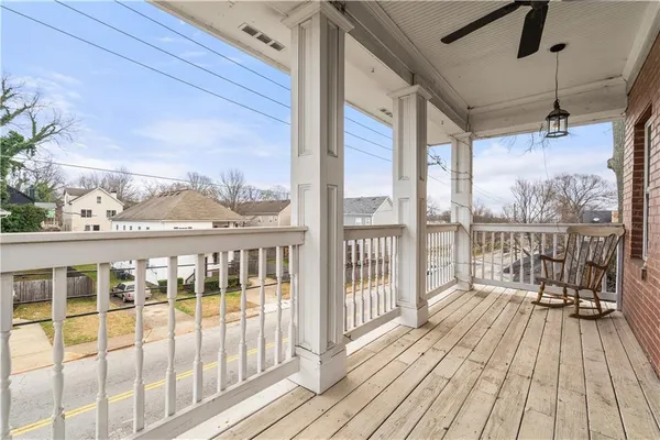 a view of a balcony with wooden floor