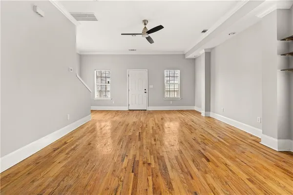 wooden floor in an empty room with a window