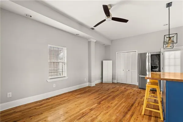 a bedroom with a bed closet and a window