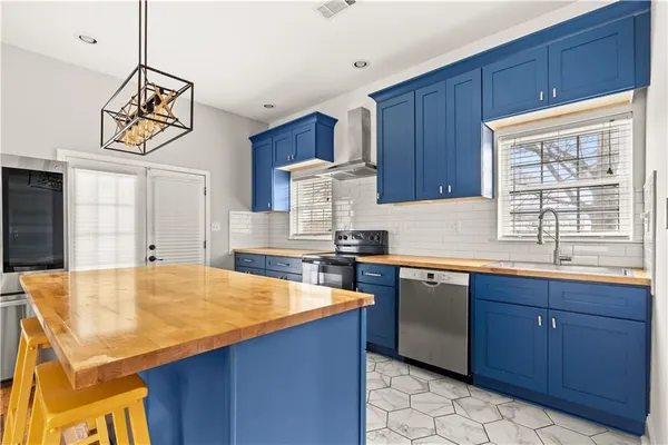 a kitchen with stainless steel appliances granite countertop a sink and a stove