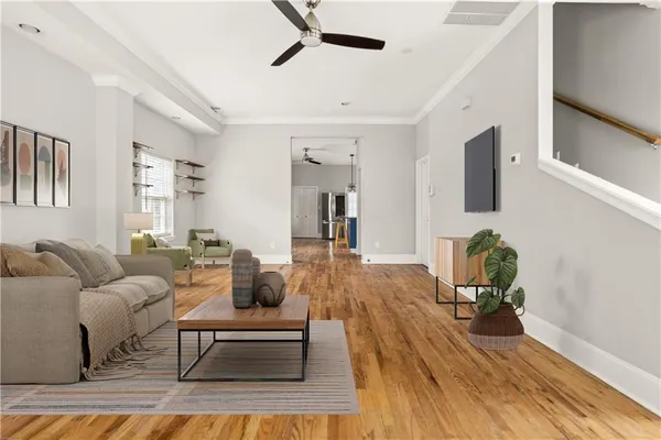 a living room with furniture and wooden floor