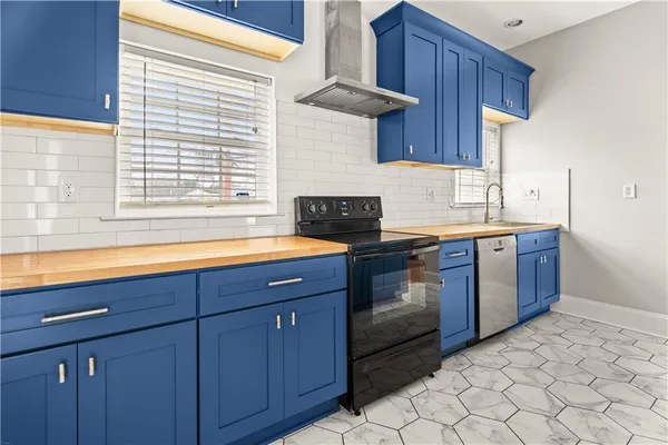 a kitchen with a sink stove and cabinets