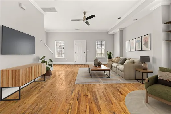 a living room with furniture and a flat screen tv