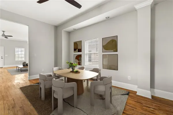 a view of a dining room with furniture and wooden floor