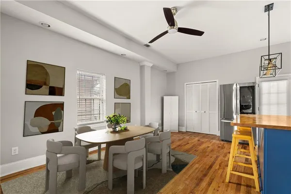 a view of a dining room with furniture and wooden floor