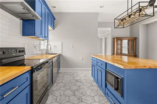a kitchen with stainless steel appliances granite countertop a sink and a stove