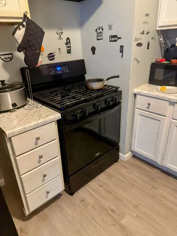 a kitchen with a stove and cabinets