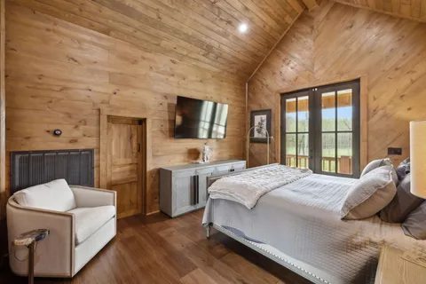 a bed sitting in a bedroom next to a window