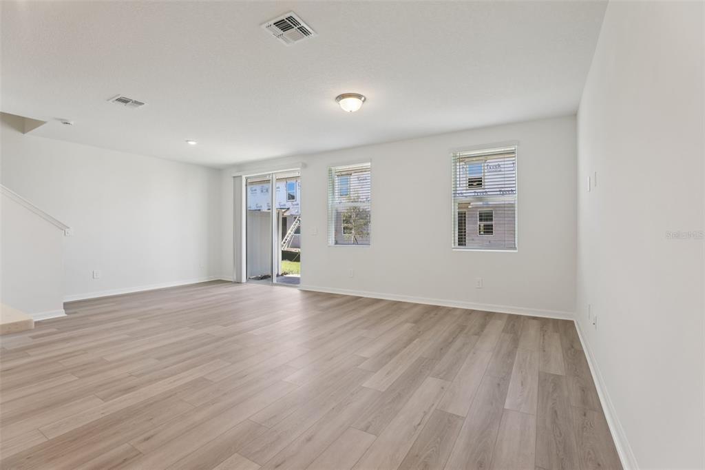 4264 Ranch House Road St. Cloud, FL 34772 - Photo 10 of 74 a view of an empty room with wooden floor and a window