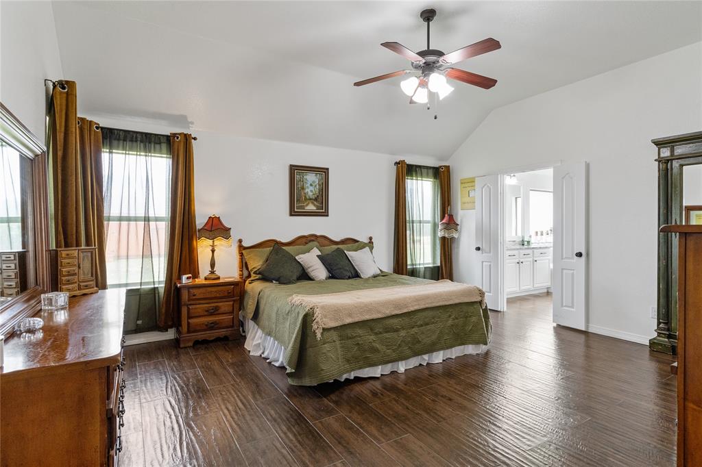 5965 Feather Wind Way Fort Worth, TX 76135 - Photo 17 of 35 a bedroom with a bed and a chandelier